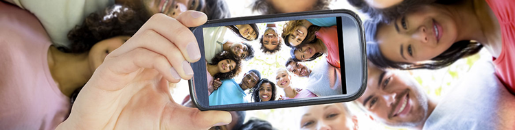 group of people in a huddle taking a selfie